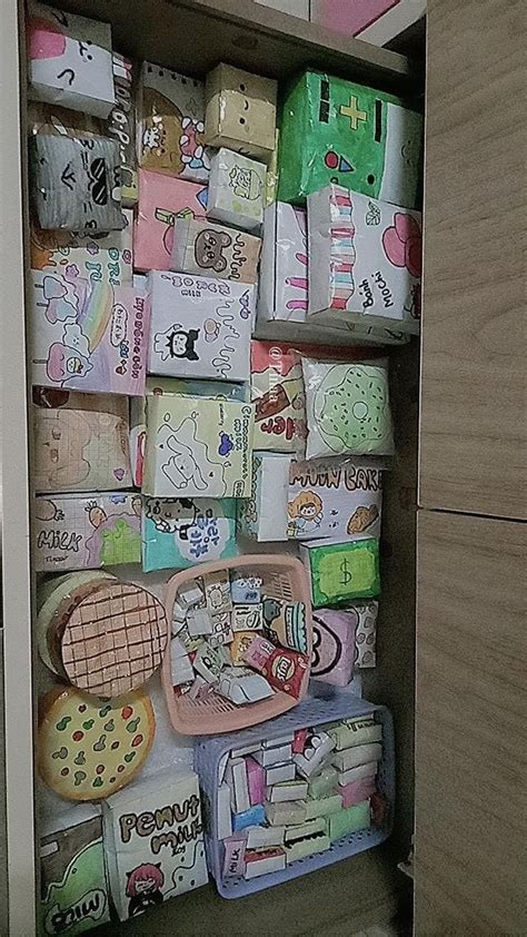 An Open Cupboard Filled With Lots Of Different Types Of Paper And Other