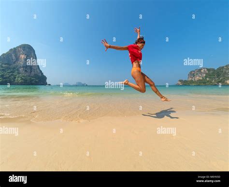 Carefree Woman In Bikini Jumping On The Beach Stock Photo Alamy