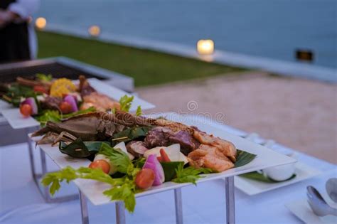 Luxury Dinner Table By The Ocean With Lobster Fish And Thai Food Stock