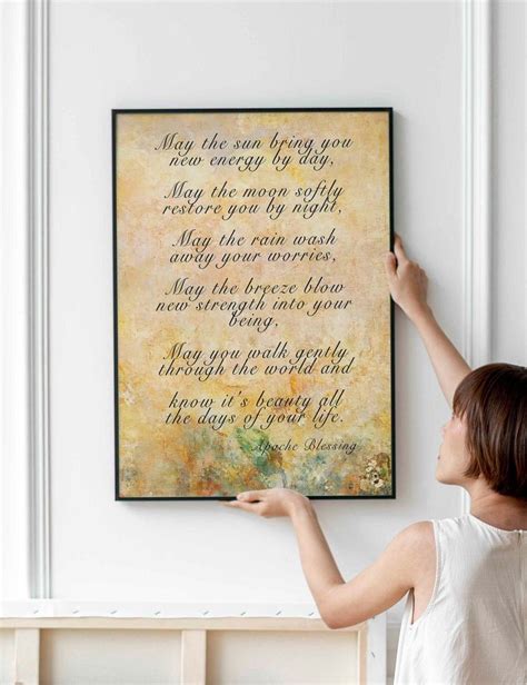 A Woman Is Holding Up A Framed Poem