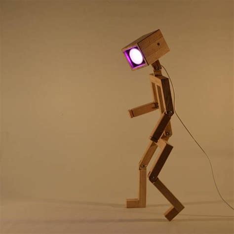 A Wooden Robot With A Purple Light On It S Head Is Walking Across The Floor