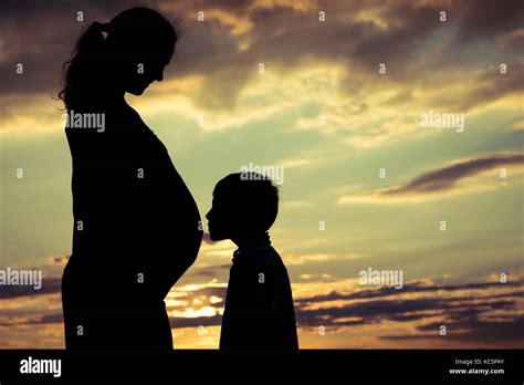 Mother And Son Walking On The Field At The Sunset Time People Having