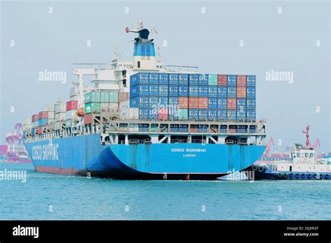 A Tugboat Undocks A Ship Of Cosco Shipping Departing From The Port Of