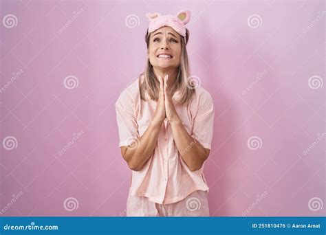 Blonde Caucasian Woman Wearing Sleep Mask And Pajama Begging And