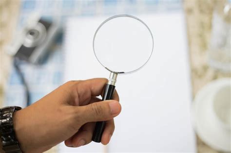 Premium Photo Close Up Of Person Holding Magnifying Glass