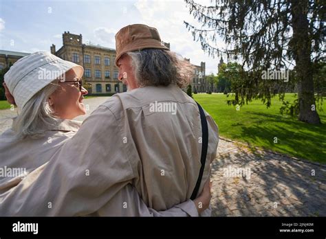 Happy Mature Female Person Embracing Her Partner Outdoors Stock Photo