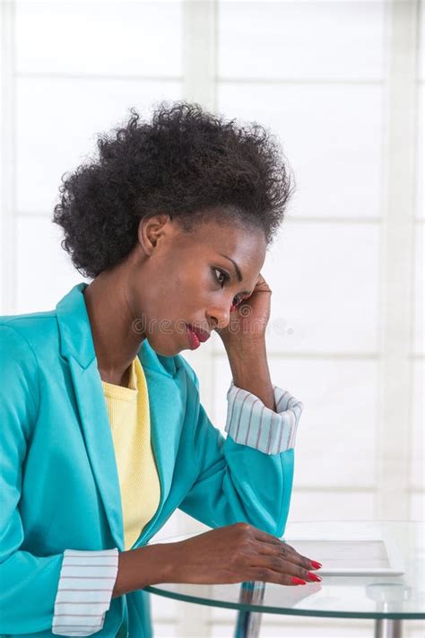 Portrait Of Mature Black Unhappy Business Woman At Desk In Office Stock