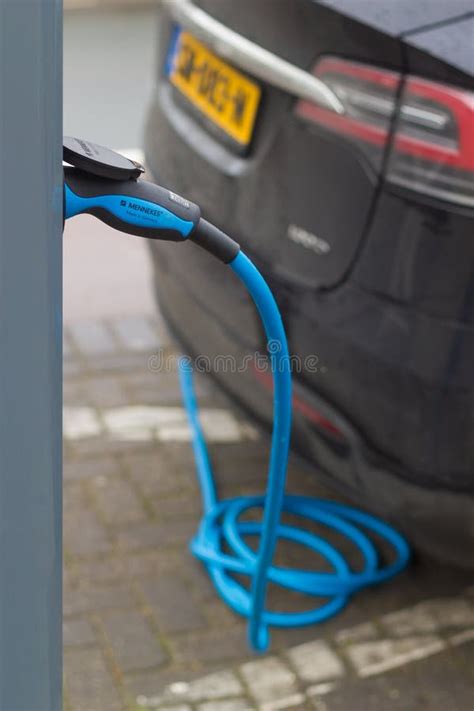 Hybrid Electric Cars Charging With Electric Plug In Power Station