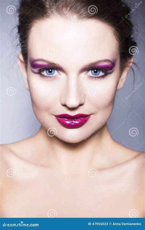 Brunette Woman With Creative Make Up Violet Eye Shadows Full Red Lips Blue Eyes And Curly Hair