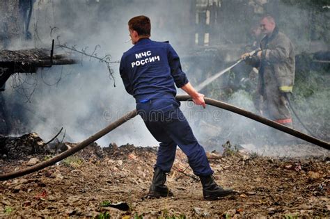 Firefighters With The Inscription On The Back In Russian `fire