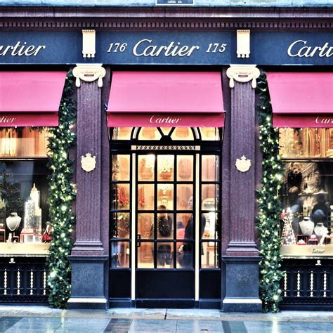 A Store Front With Pink Awnings And Christmas Decorations On The