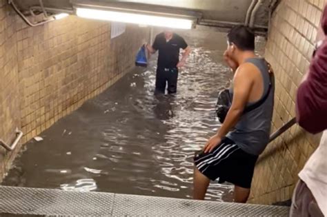 Commuters Wade Through Dirty Water As Subway Stations In New York Flood