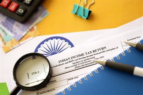 Premium Photo Indian Income Tax Return Blank Form With Pen And Indian Rupees Bills