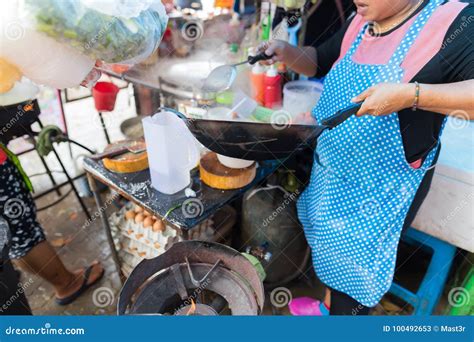 Woman Cooking Noodle Soup Outdoors On Traditional Street Market In Asia