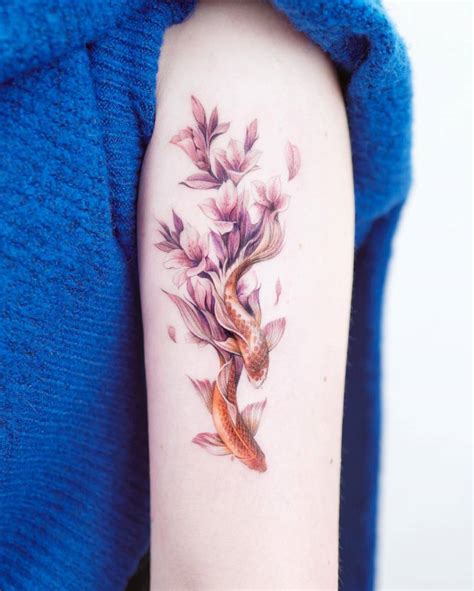 Koi Fish And Lily Flower Tattoo Located On The Tricep