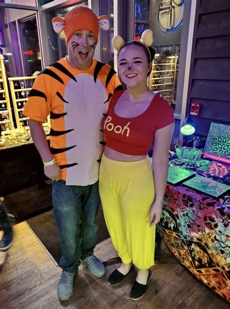 A Man And Woman Dressed Up As Winnie The Pooh And Tigger For Halloween