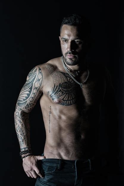 Premium Photo Bearded Man With Strong Torso Man With Tattooed Arm And Chest Tattoo Model With