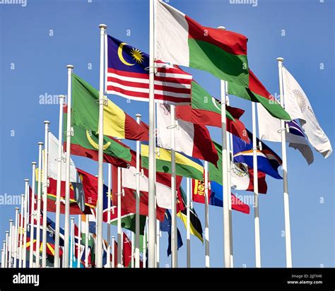 The Waving Flags Of The Different Countries On The Poles During The