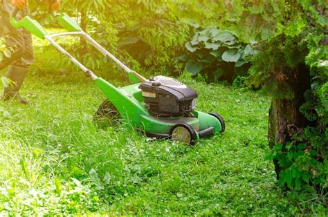 Premium Photo | Lawn mower on green grass lawn