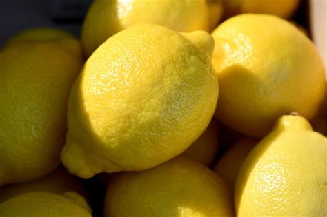 Premium Photo A Bunch Of Lemons Are Stacked In A Basket