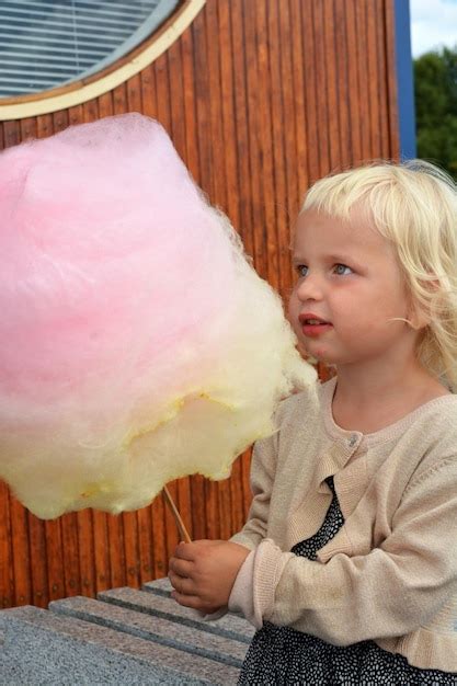 Premium Photo Close Up Of Girl Holding Cotton Candy