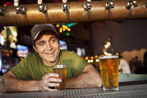 Caucasian Man Drinking Beer In Bar Автор Фотографии