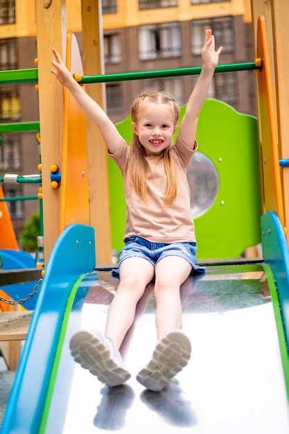 Premium Photo | Baby girl on the playground in the yard of the house in ...