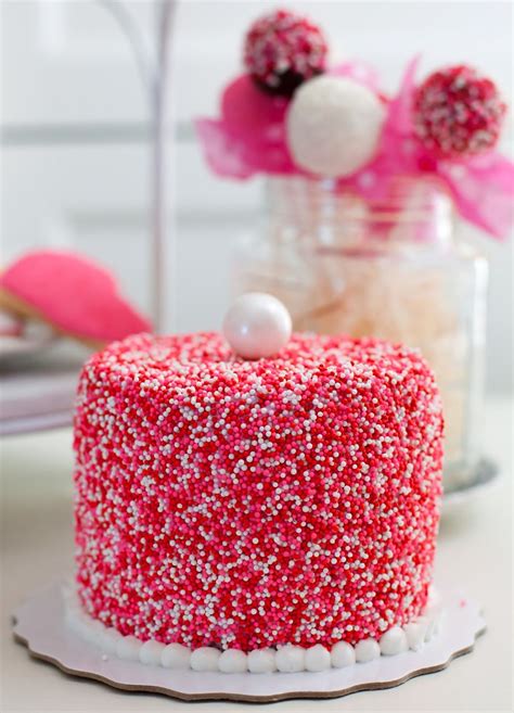 A Pink Red And White Sprinkled Covered Cake For Valentines Day By