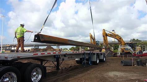 Using A Crane To Load Steel Sheet Pile Onto A Trucks Flat Bed At