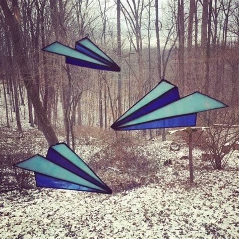 Three Stained Glass Wind Chimes In The Woods On A Snow Covered Ground