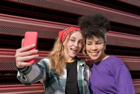 Premium Photo Two Multiracial Women Taking Selfie In The Street