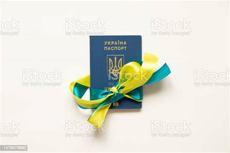 Foreign Biometric Passport Tied With A Ribbon From The Flag Of Ukraine