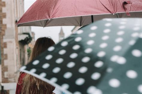 Premium Photo Rear View Of Woman Holding Umbrella In Rain