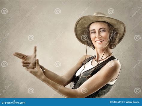 Woman In Cowboy Hat Making Gesture With Hands Pretending Gun Stock