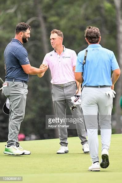 Jon Rahm Of Spain Smiles While Greeting Justin Thomas On The 18th