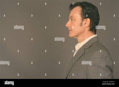 Mature Handsome Businessman Against Gray Background Stock Photo Alamy