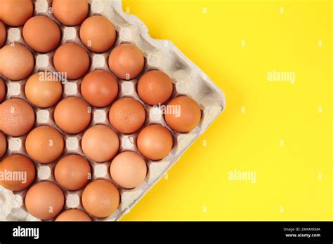 Raw Chicken Eggs On Yellow Background Top View Stock Photo Alamy