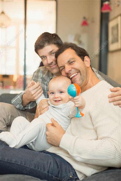 Portrait Male Gay Parents And Baby Son With Rattle Stock Image F