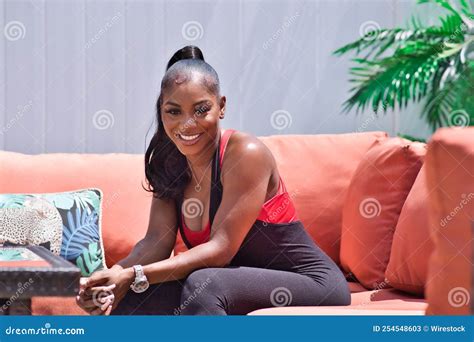 Portrait Of A Black Woman Sitting On A Sofa In Backyard Stock Image