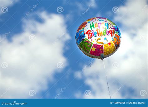 Colorful Happy Birthday Balloon On A Blue Sky Background Stock Photo