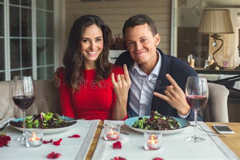 Young Couple Having Romantic Dinner In The Restaurant Sitting Together