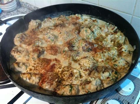 A Pan Filled With Food Sitting On Top Of A Stove Next To A Burner