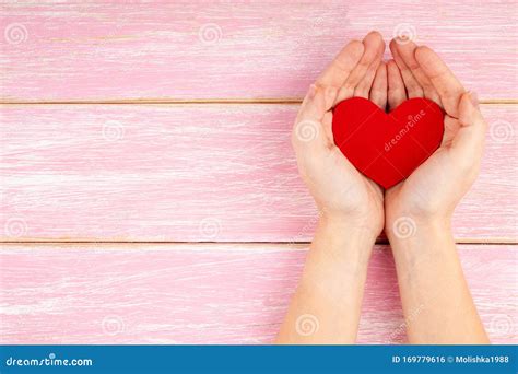 Woman Hands Holding Red Heart On Pink Wooden Background Health Care