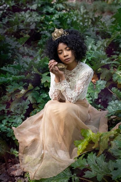 Premium Photo Calm Ethnic Lady With Nest In Hand Sitting In Forest