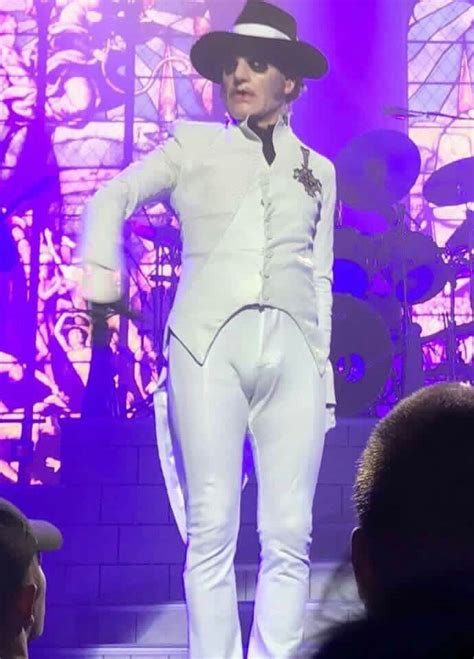 A Man In White Suit And Hat On Stage