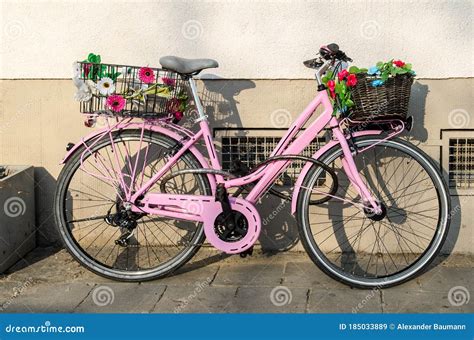 Old Pink Bicycle with Flowers in Front of a Building Stock Image ...