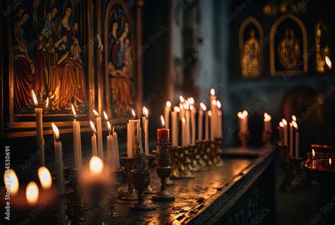 lighted prayer candles in an Orthodox Christian church against a gloomy ...