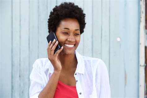 Young Black Woman Smiling And Talking On Mobile Phone Stock Image