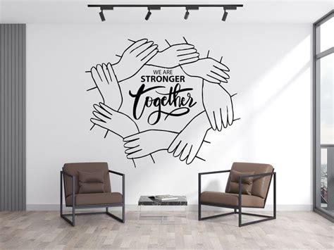 A Wall Decal With The Words We Are Strong Together And Hands Holding