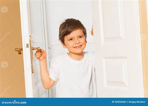 Child Holding Door Open At School